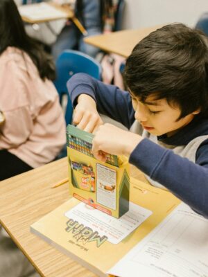 Children engaged in learning activities in a classroom, showcasing school life.